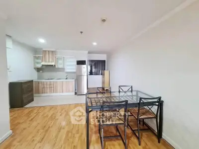 Spacious open-plan kitchen and dining area with modern appliances and wooden flooring.