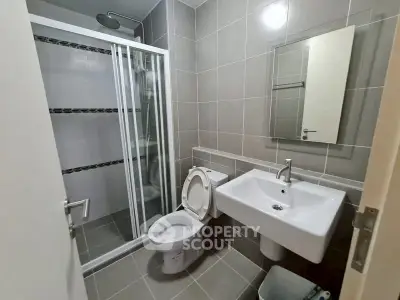 Modern bathroom with sleek shower and contemporary fixtures in stylish apartment.