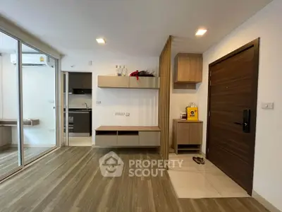 Modern apartment interior with wooden flooring and sleek kitchen design