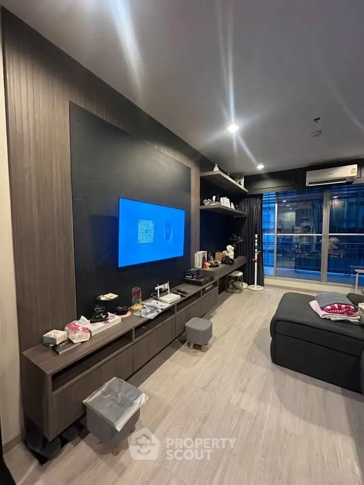 Modern living room with sleek entertainment center and large window view.