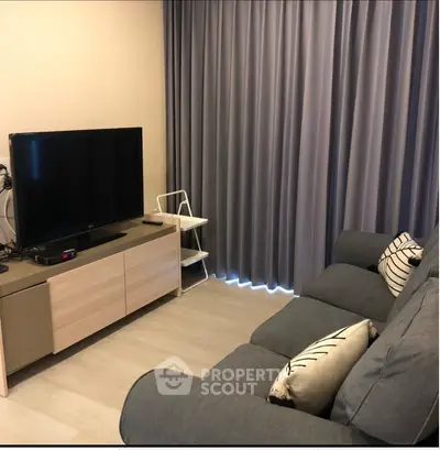 Cozy living room with modern TV setup and comfortable sofa