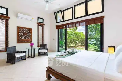 Luxurious bedroom with garden view and elegant decor in tropical setting