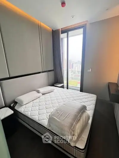 Modern bedroom with large window and city view in luxury apartment