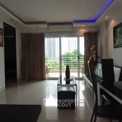 Spacious living room with modern decor and balcony view in urban apartment.