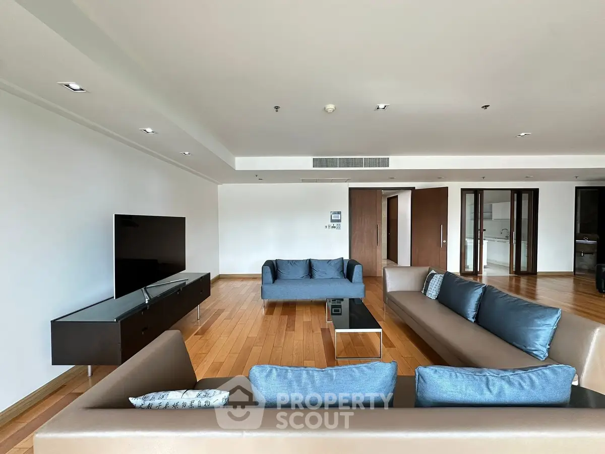 Spacious modern living room with sleek furniture and wooden flooring