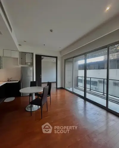 Spacious modern kitchen with open layout and large balcony access