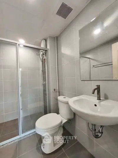 Modern bathroom with sleek fixtures and glass shower enclosure