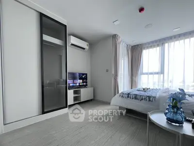 Modern bedroom with sleek design, large windows, and stylish decor