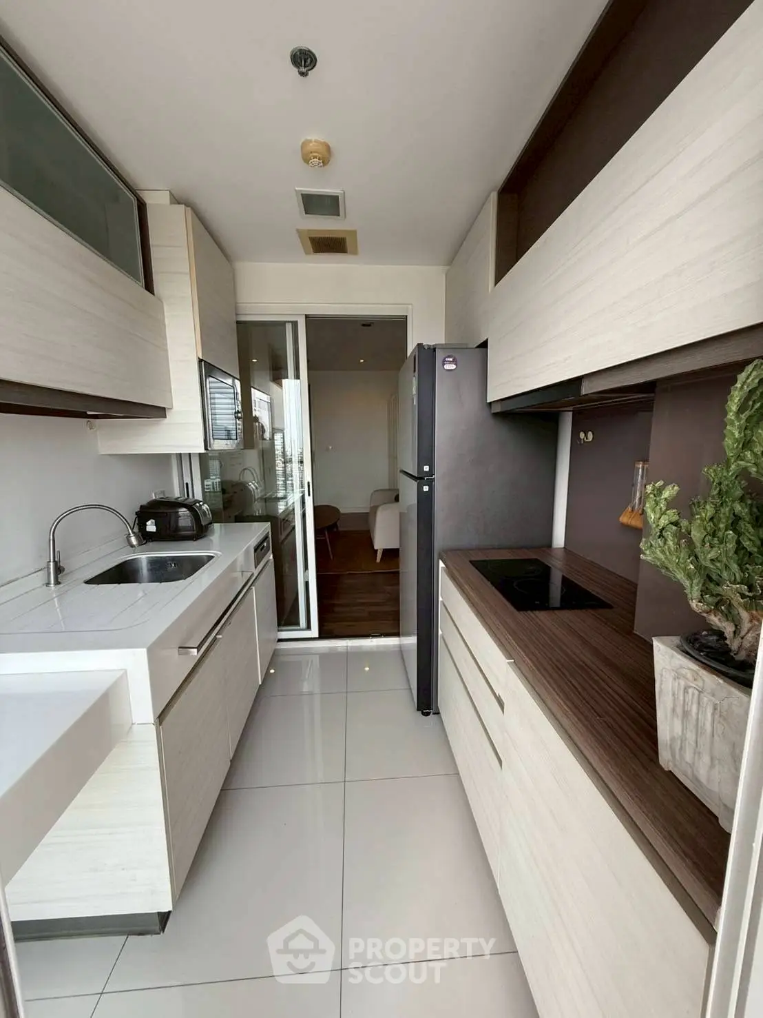 Modern kitchen with sleek cabinetry and integrated appliances in a stylish apartment.