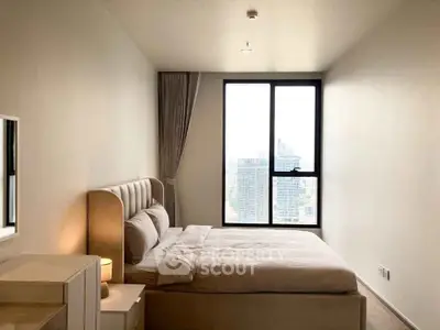 Modern bedroom with city view, featuring a cozy bed and large window for natural light.