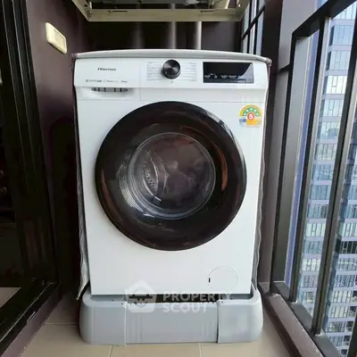 Modern washing machine on a balcony with city view, perfect for urban living convenience.