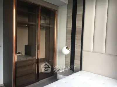 Modern bedroom with sleek wardrobe and stylish lighting