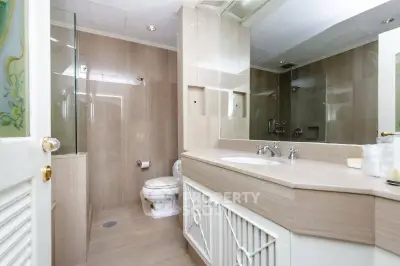 Elegant bathroom with modern fixtures and spacious vanity in a luxurious home.