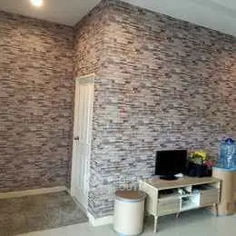 Modern living room with stylish stone accent wall and sleek furniture