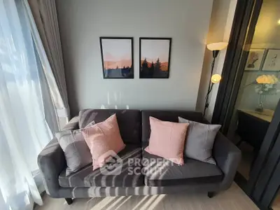 Cozy living room with stylish sofa and modern decor, perfect for relaxation and entertaining.
