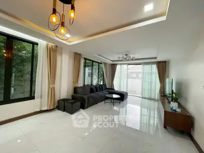 Spacious modern living room with elegant lighting and large windows