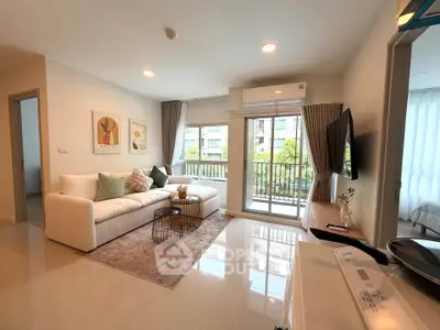 Modern living room with cozy sofa, stylish decor, and balcony view in a bright apartment.