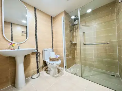 Modern bathroom with glass shower and elegant fixtures in a stylish real estate property.