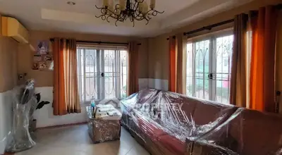 Spacious living room with elegant chandelier and large windows