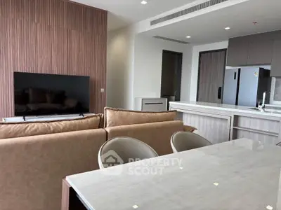Modern open-plan living room with sleek kitchen and stylish furniture