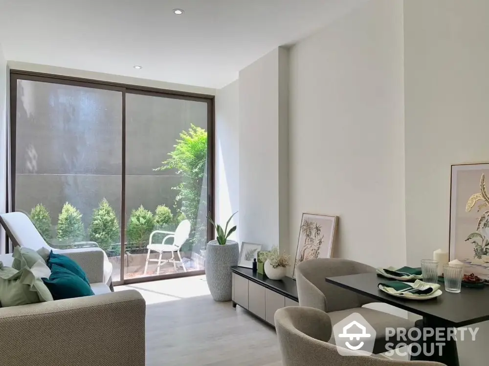 Modern living room with large window and stylish furniture, perfect for urban living.