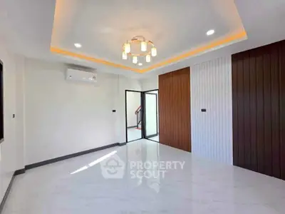 Spacious modern living room with elegant lighting and stylish wall design