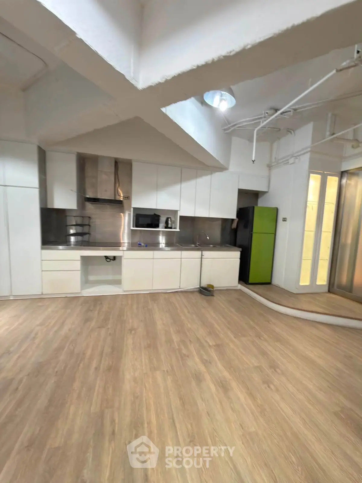 Spacious modern kitchen with sleek cabinetry and stainless steel appliances in a bright open layout.