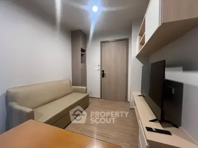 Modern living room with sleek furniture and flat-screen TV