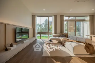 Spacious modern living room with large windows and elegant decor