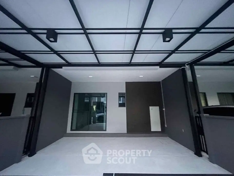 Modern covered parking space with sleek design and ample lighting