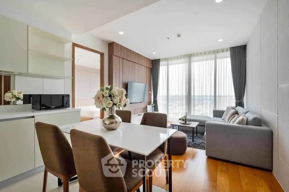 Modern living room with elegant decor and large windows offering stunning city views.