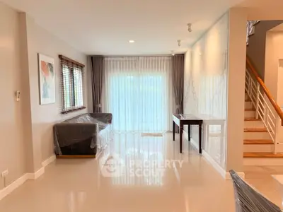Spacious living room with modern decor and large windows for natural light