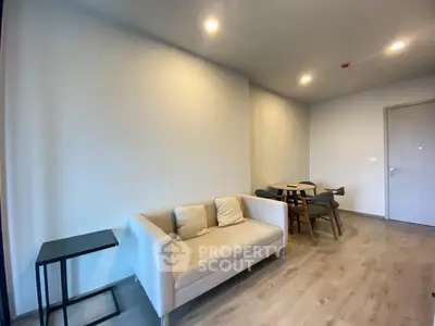 Modern living room with cozy sofa and dining area in minimalist style.