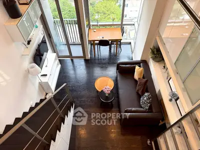 Stunning modern living room with high ceilings and balcony view, perfect for urban living.