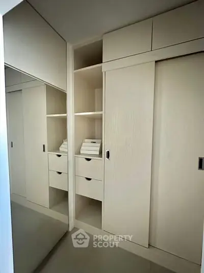 Modern built-in wardrobe with sliding doors and ample storage space