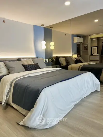 Modern bedroom with stylish decor and mirrored wall