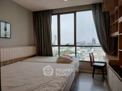 Spacious bedroom with city view, featuring large window and modern furnishings.