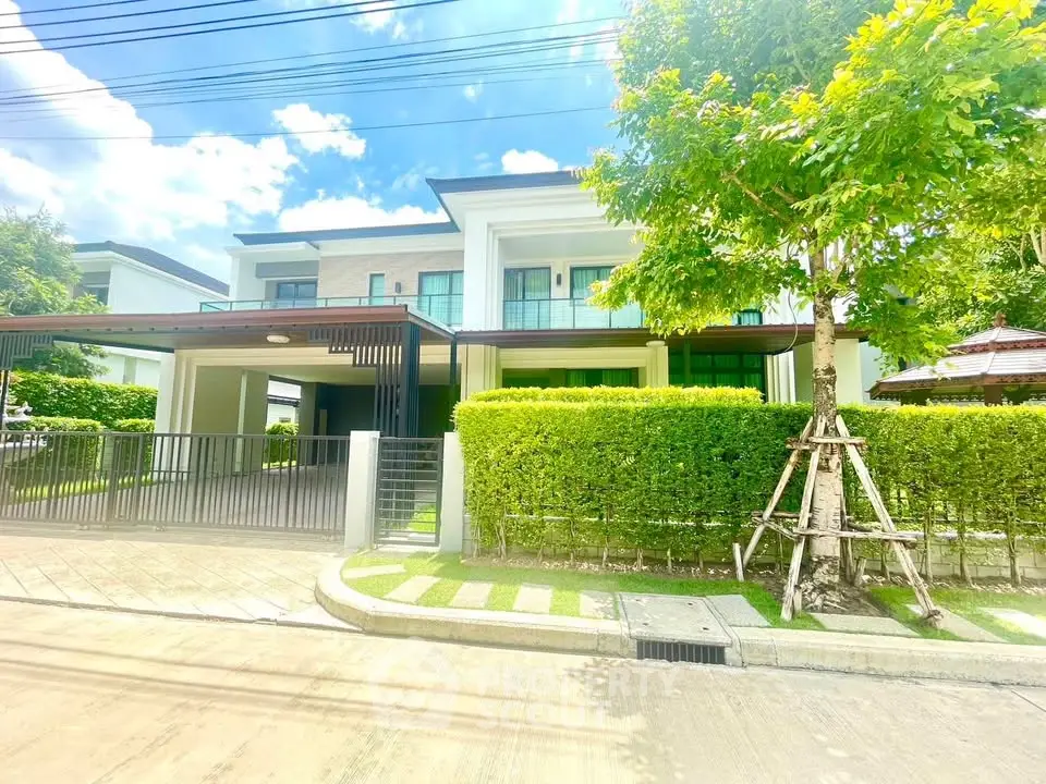 Modern two-story house with lush greenery and spacious driveway in a serene neighborhood.