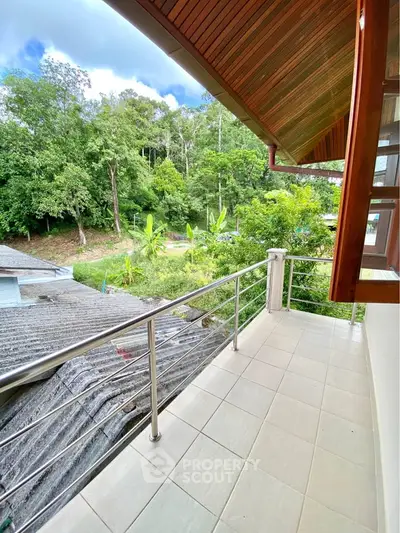Charming balcony with lush green view, perfect for relaxation and enjoying nature.