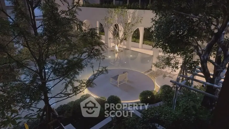 Luxurious outdoor garden with ambient lighting and elegant seating area in a modern real estate property.