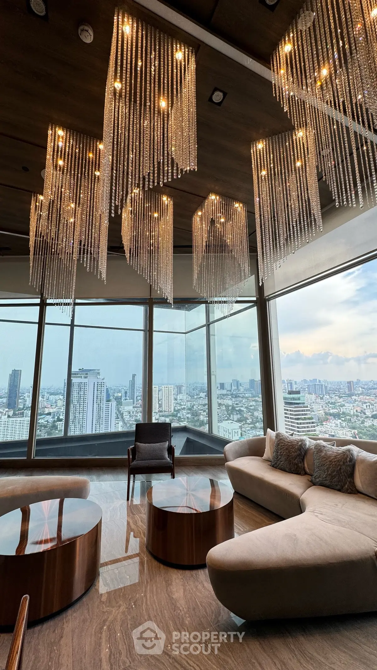 Luxurious living room with stunning city view and elegant chandeliers
