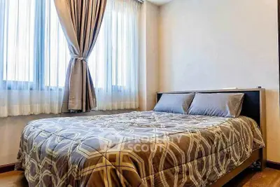 Cozy bedroom with large windows and elegant curtains, featuring a comfortable double bed and stylish bedding.