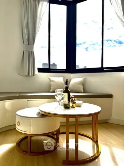 Stylish living room with elegant furniture and large windows offering natural light.