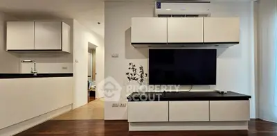 Modern living room with sleek cabinetry and wall-mounted TV