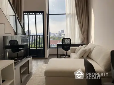 Spacious modern living room with large windows and city view, perfect for urban living.