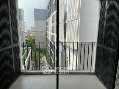 Modern apartment balcony with city view and sleek railing design.