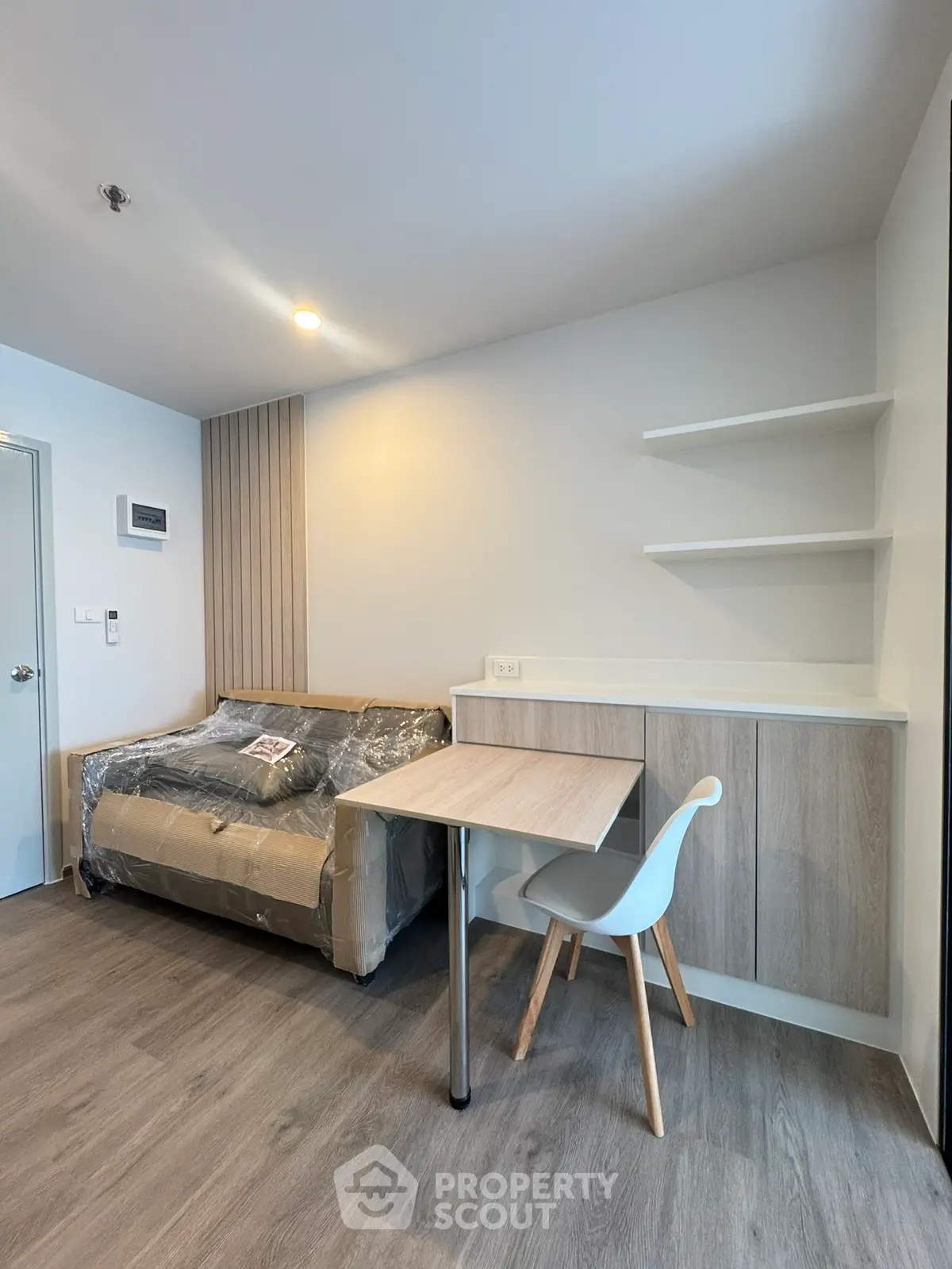 Modern minimalist living room with sleek furniture and wooden flooring