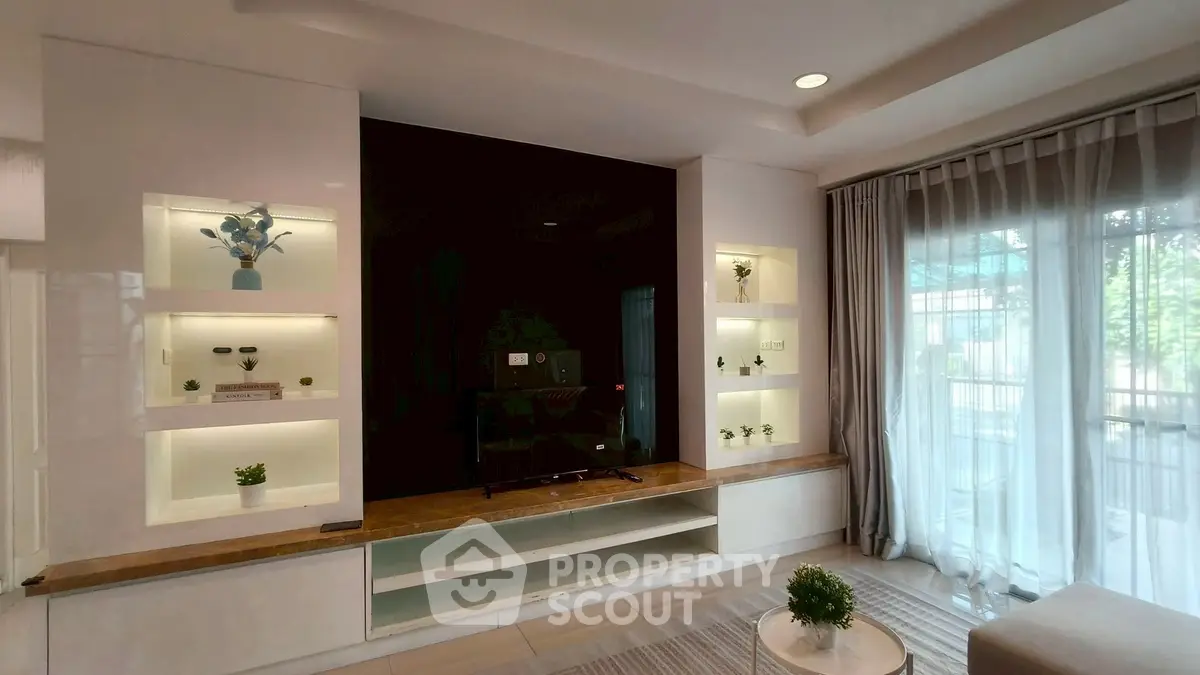 Elegant living room with modern built-in shelves and large window for natural light