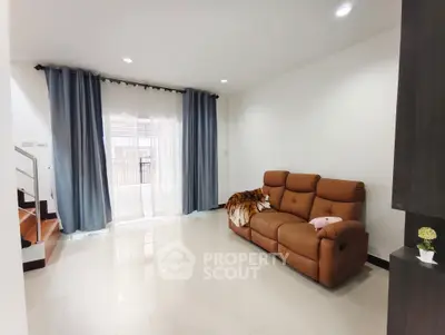 Spacious living room with modern sofa and large window for natural light