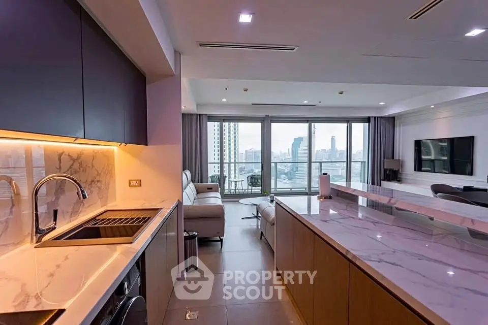 Luxurious open-plan kitchen and living room with city view and modern amenities.